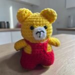 Handmade yellow crochet teddy bear with red outfit amigurumi toy