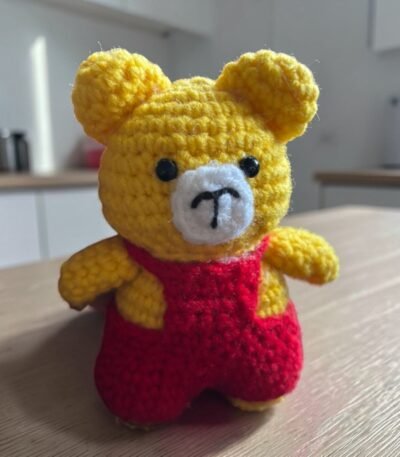 Handmade yellow crochet teddy bear with red outfit amigurumi toy