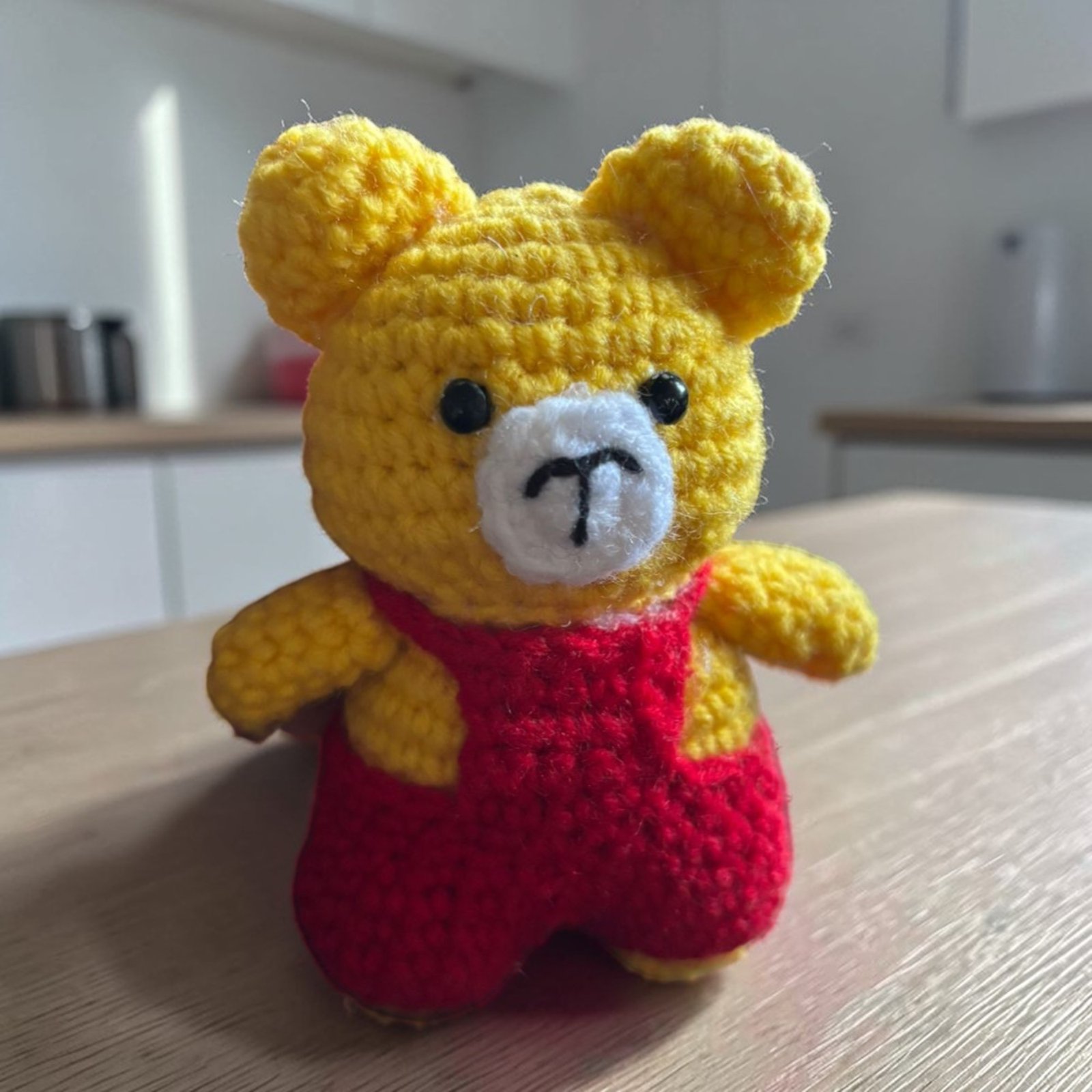 Handmade yellow crochet teddy bear with red outfit amigurumi toy