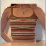 Woman wearing handmade multicolor crochet striped crop tank top with spaghetti straps