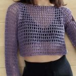 Woman wearing handmade lavender crochet mesh long sleeve crop top