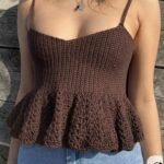 Woman wearing handmade brown crochet camisole top with flared hem